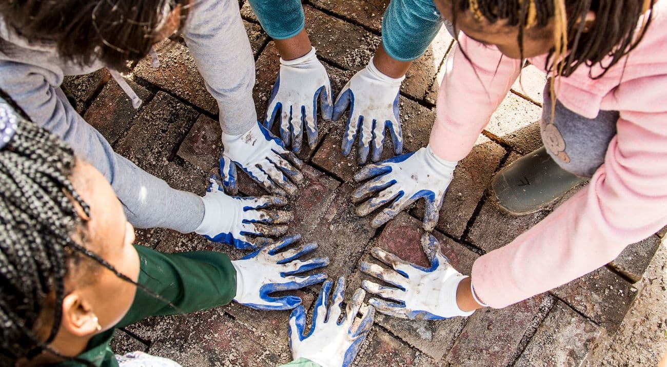 Group of people with hands together in collaboration